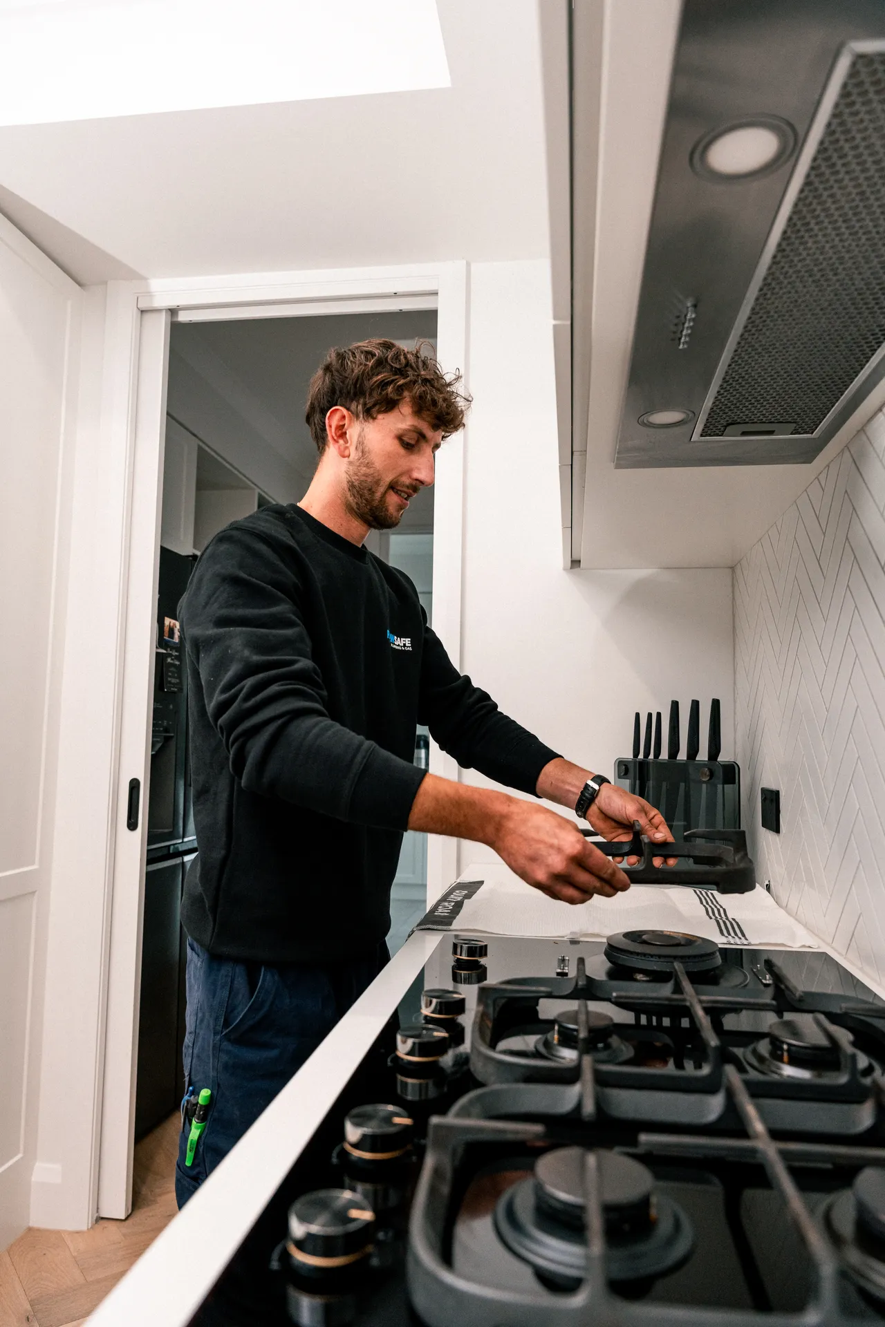 Licensed gas fitter installing a gas cooktop