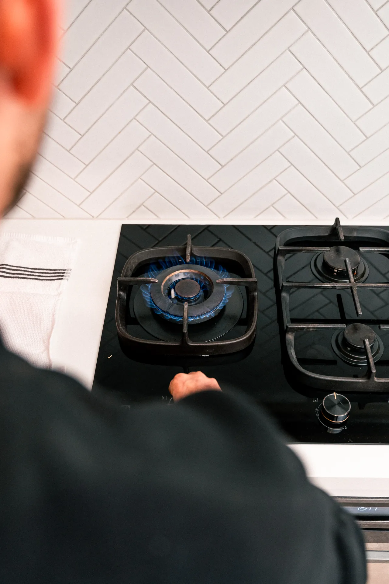 Licensed gas fitter installing a gas cooktop