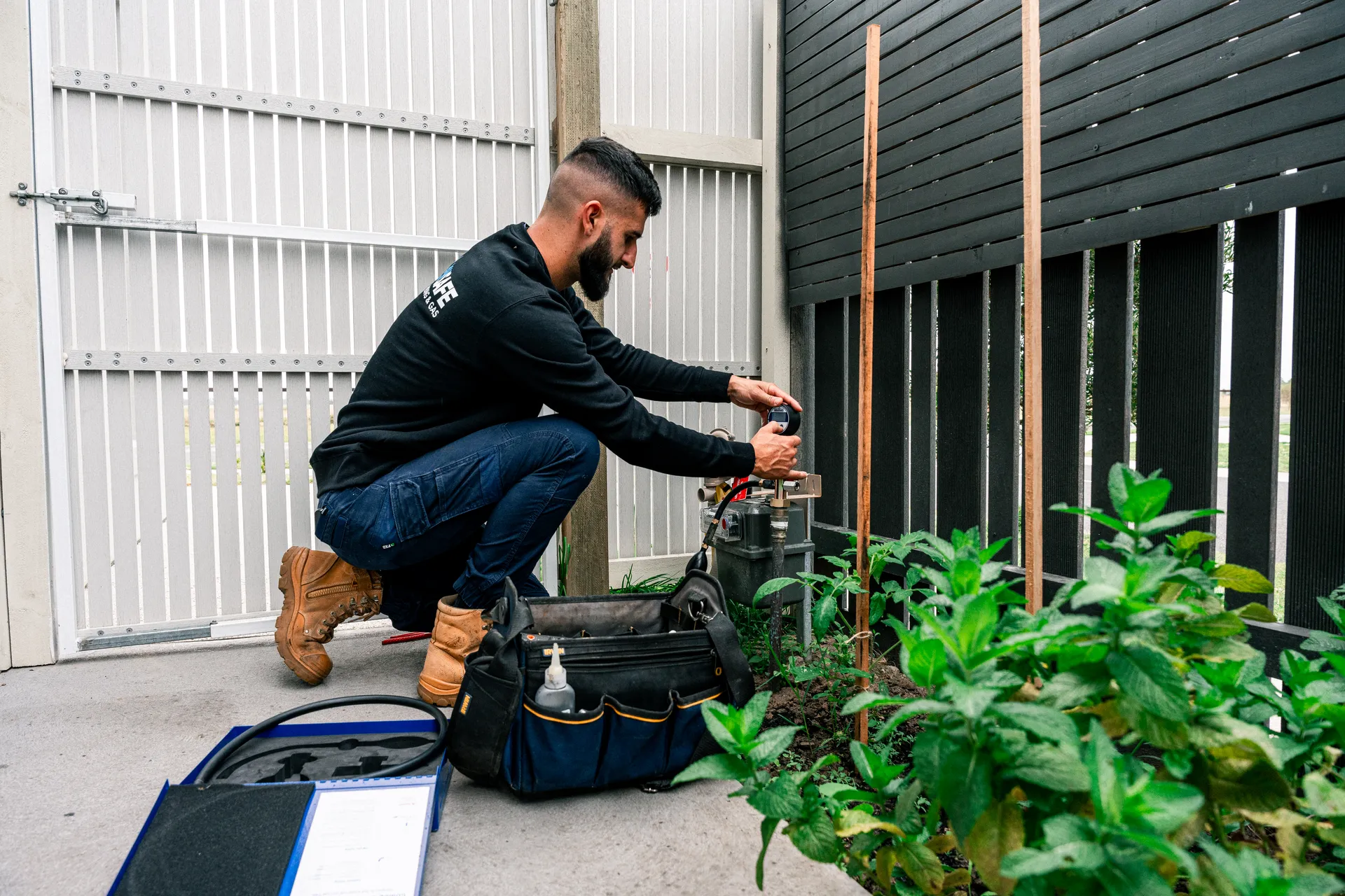 Technician working on ducted gas heating pipework